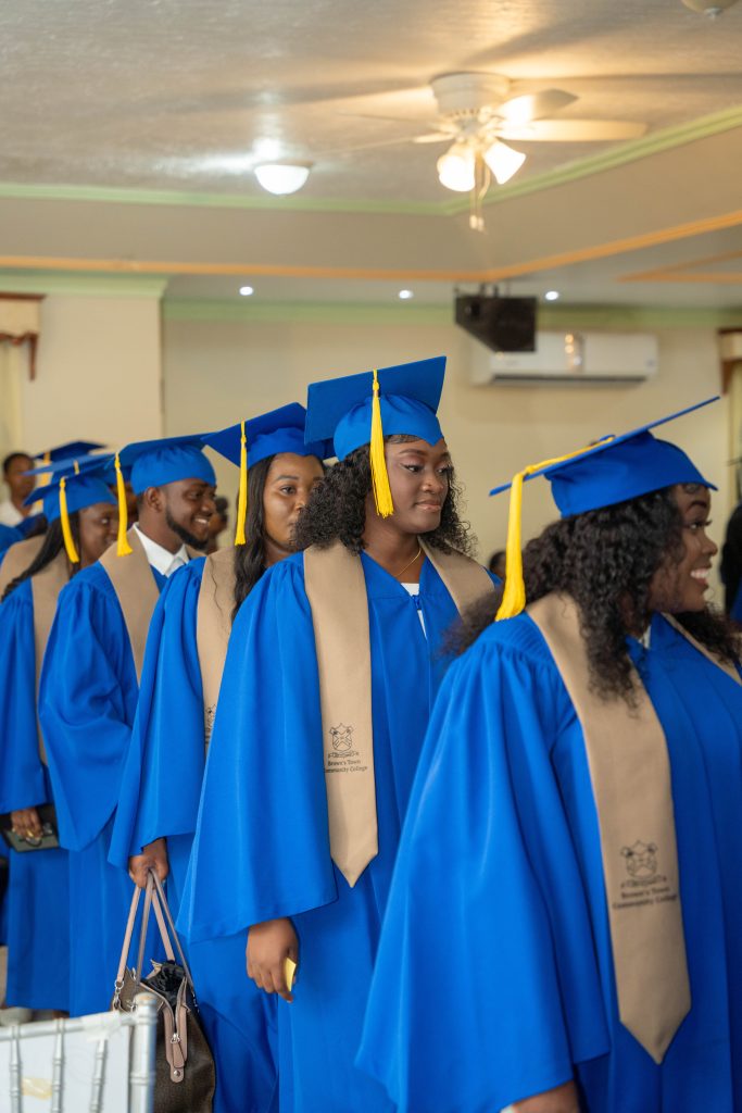 Graduands lining up in blue caps and gowns