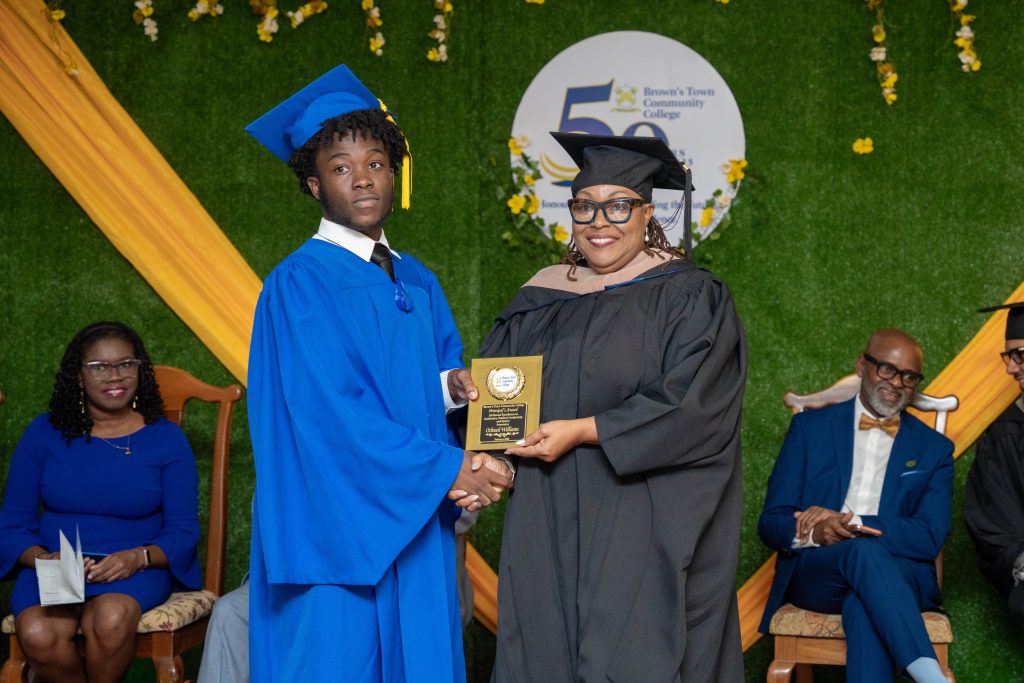 A graduate receiving an award on stage